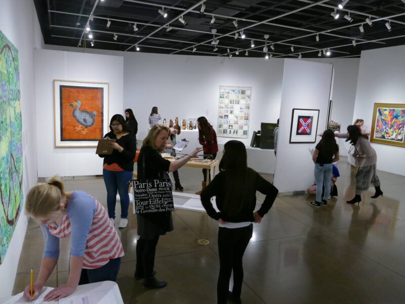Children visiting the Speaking Volumes exhibit, taking notes and asking questions.