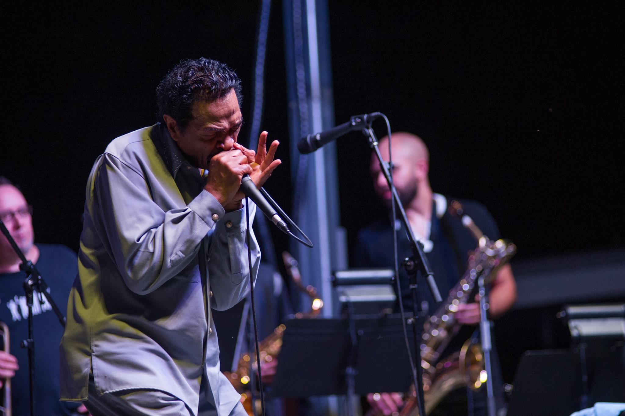 Bobby Rush playing a harmonica.