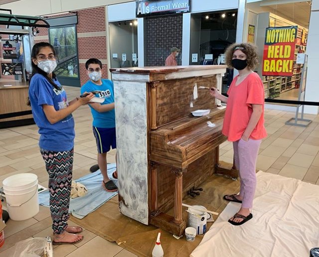 Creative Kids' Collective priming their piano.