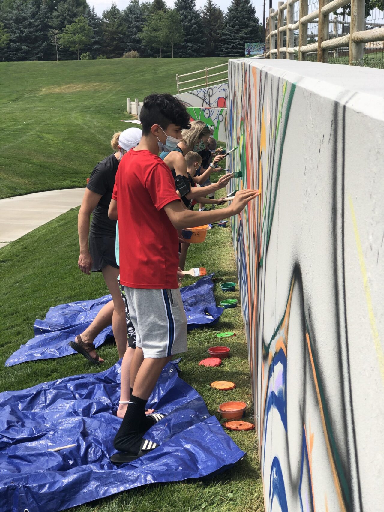 A family painting the mural.