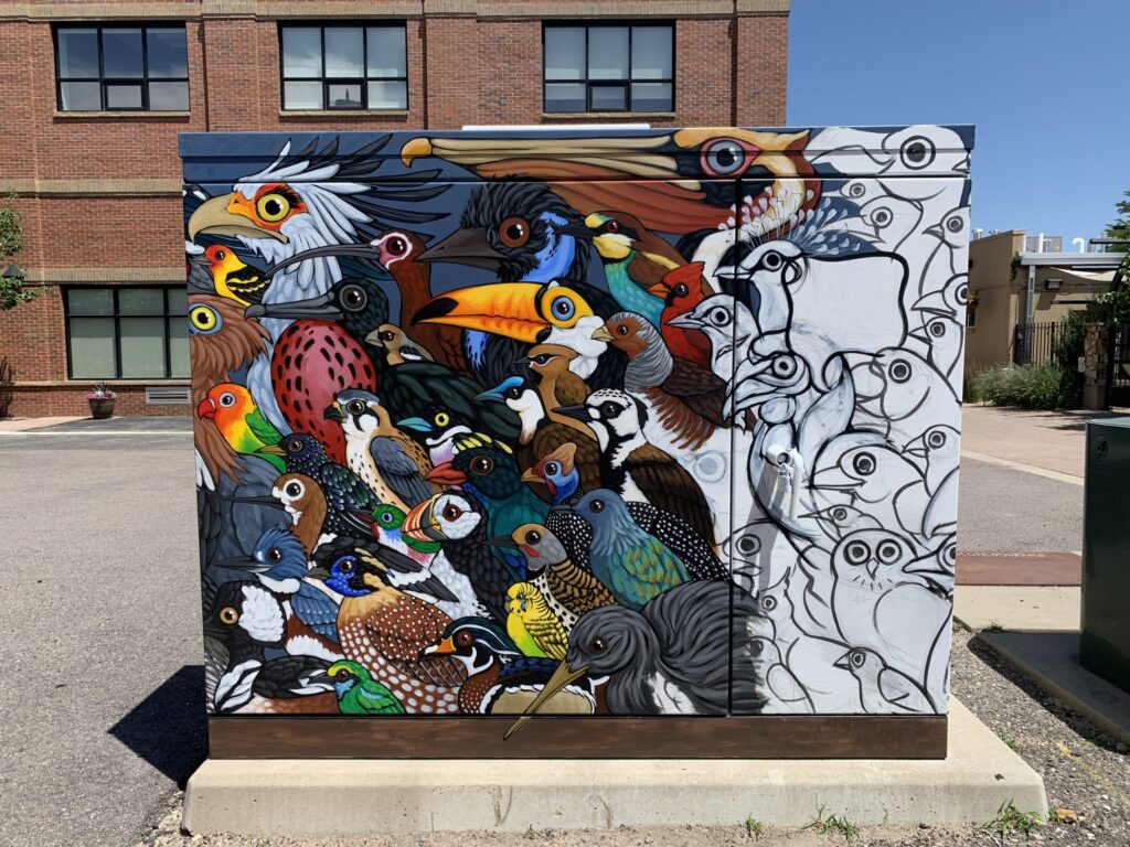 A half-painted transformer box with birds as the subject.