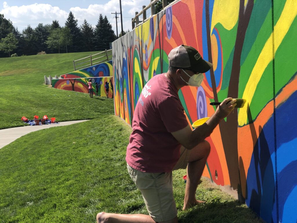 The community paining the mural in Maple Hill.