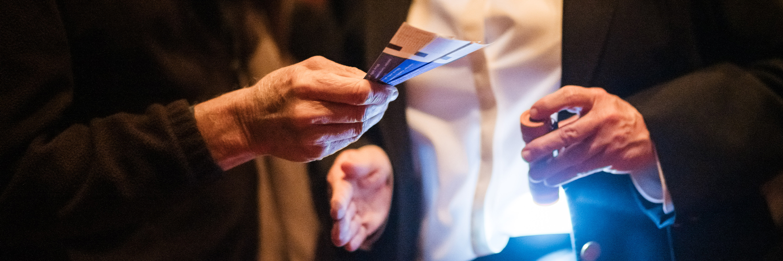 Man with show tickets in hand