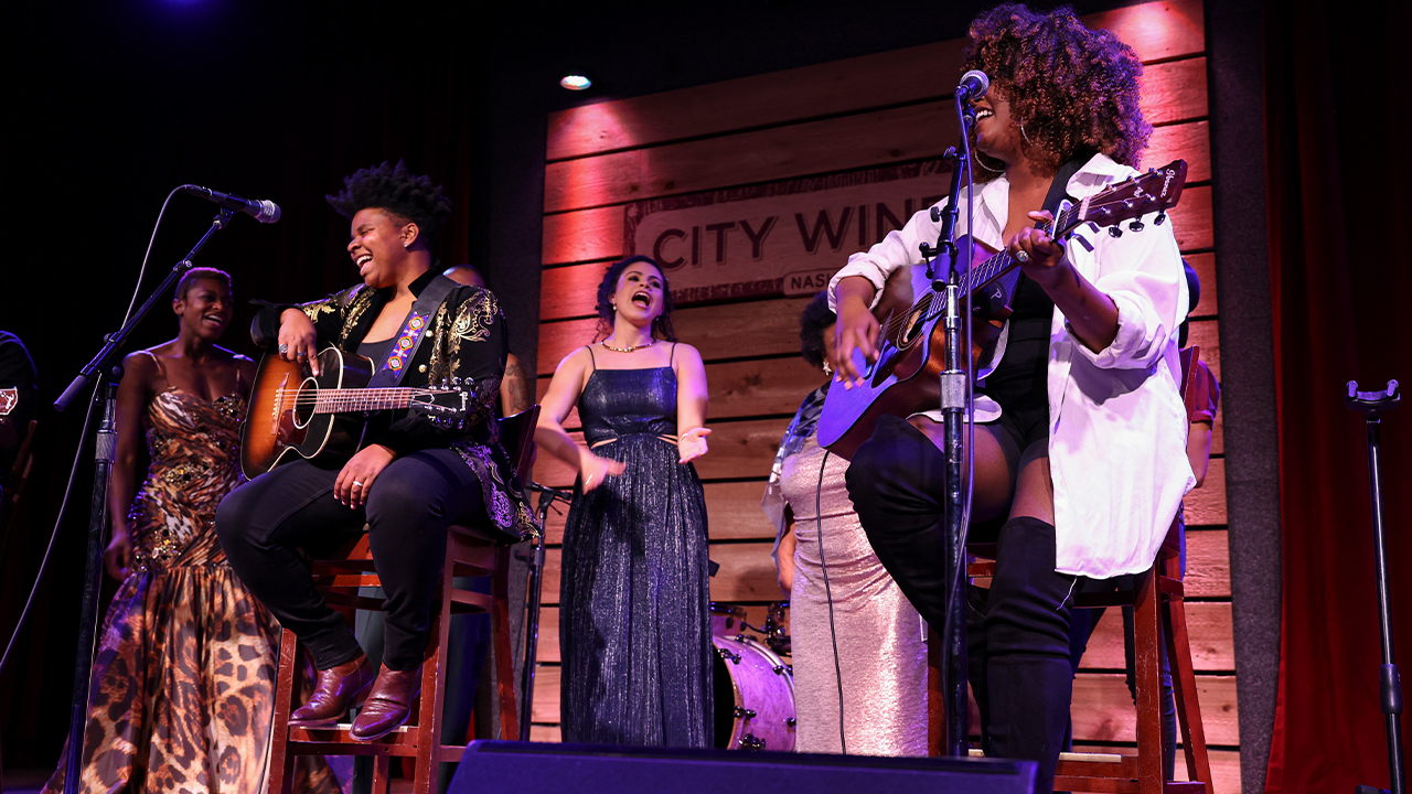 Members of The Black Opry Revue singing on stage.