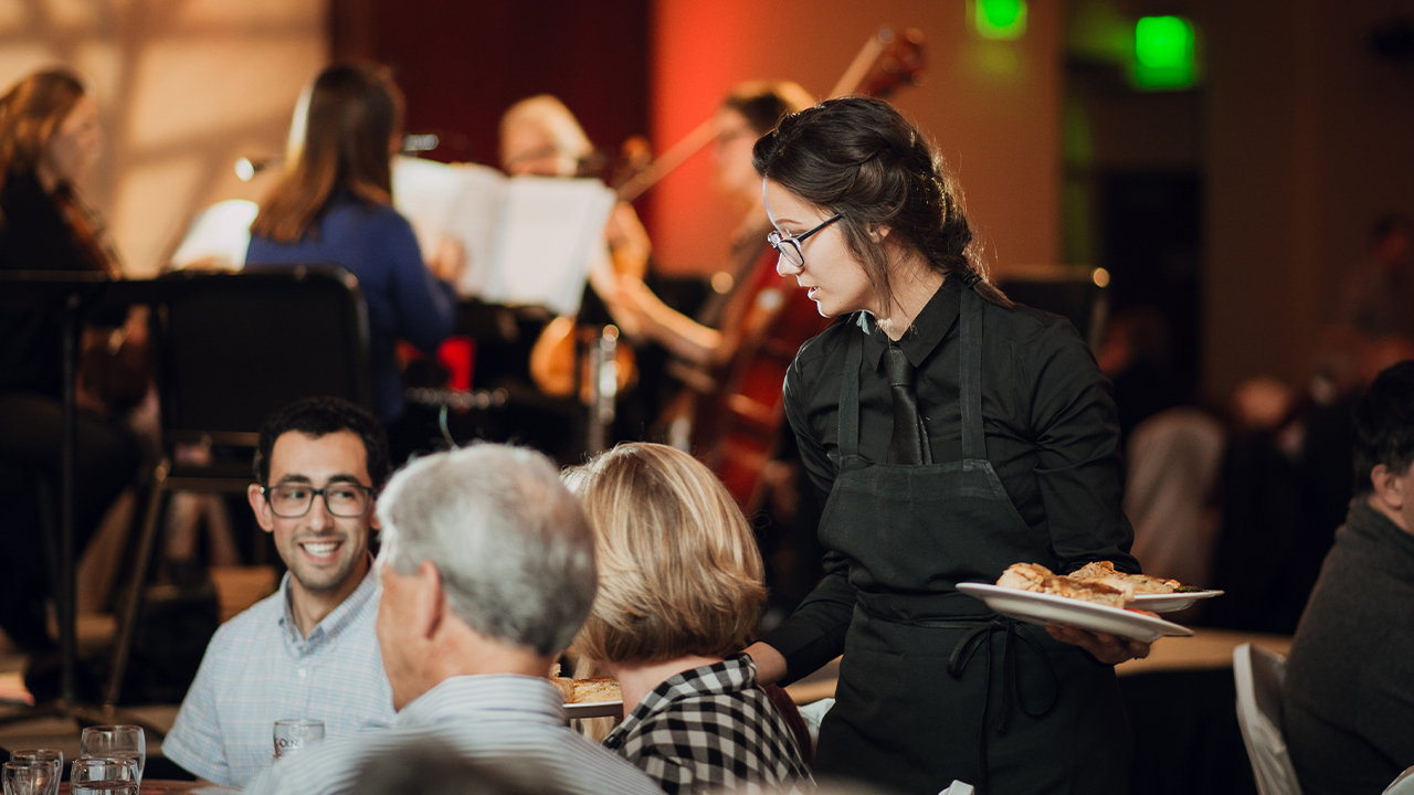 Waitstaff serves guests.