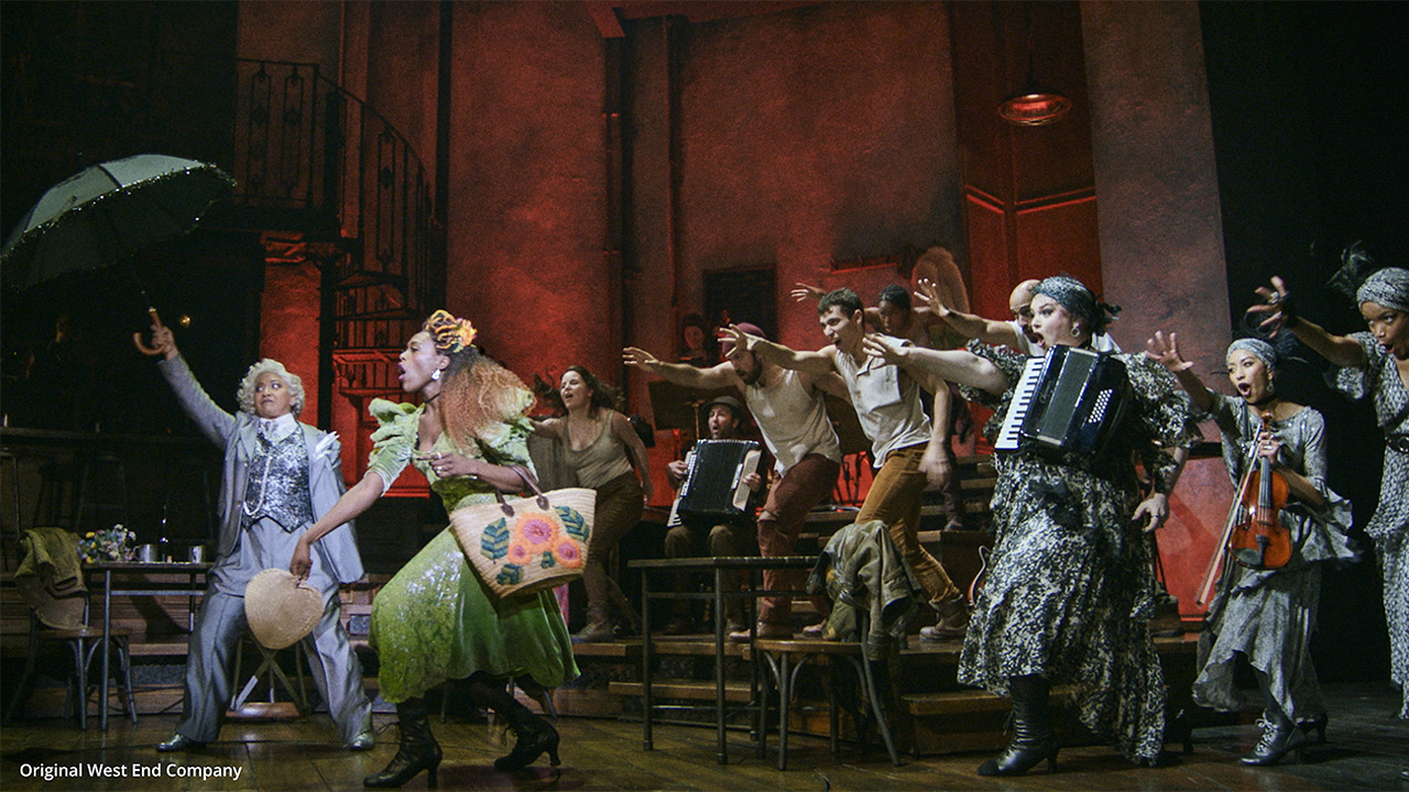 The cast singing and dancing with Persephone on stage.