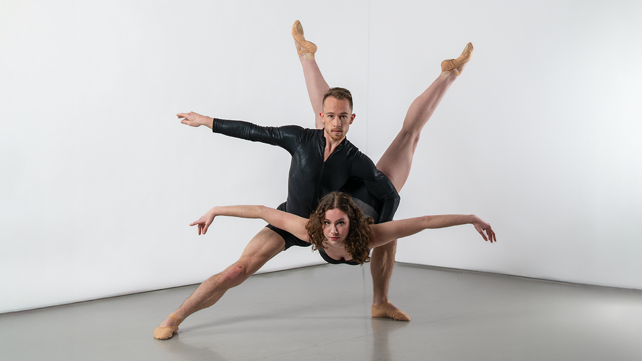 2 ballet dancers in black posing