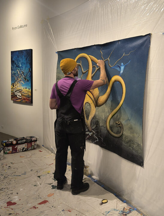 Ryan Guillaume paints a mural at the Lincoln Center Art Gallery