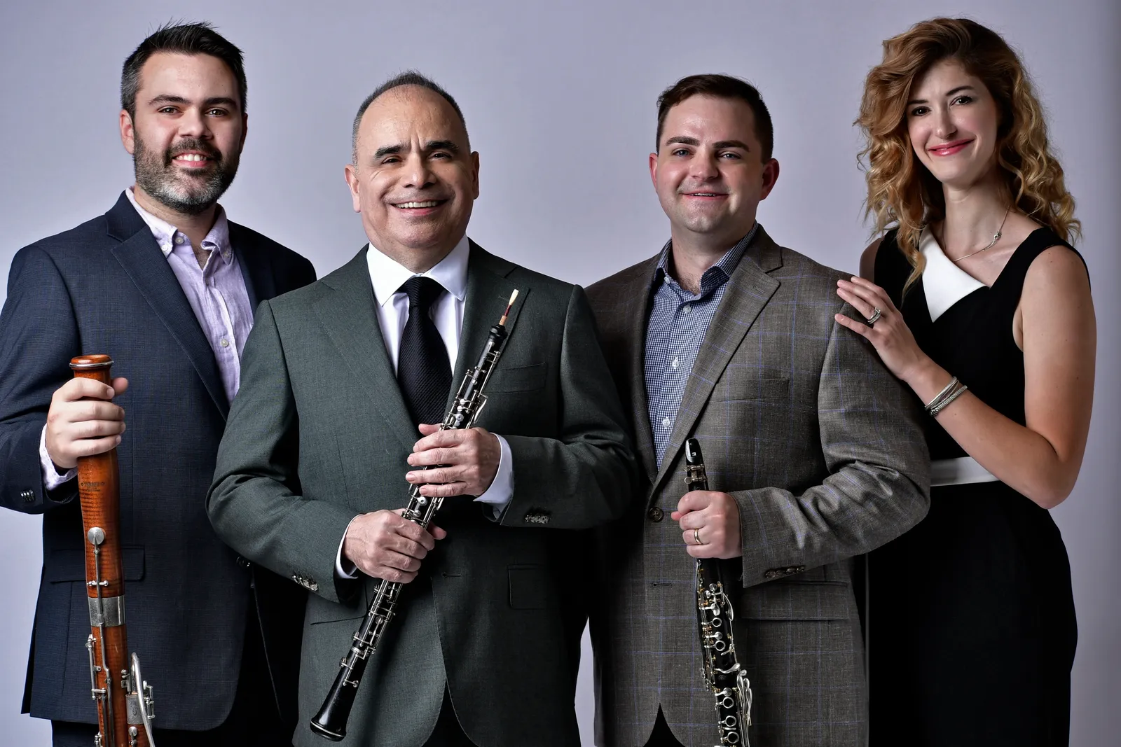 Four members of Frisson pose for a picture with their instruments