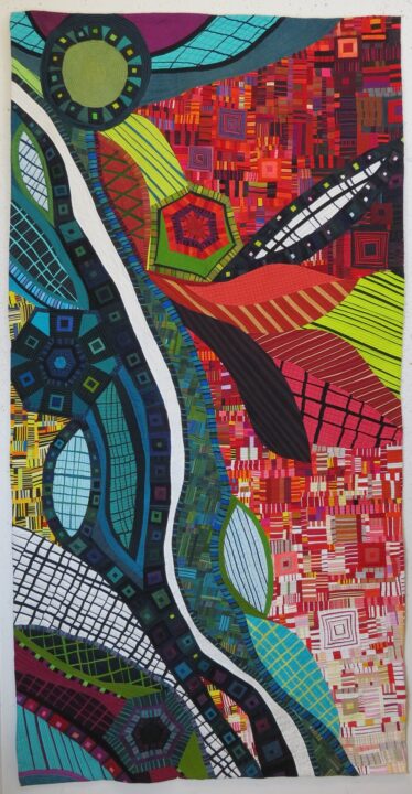Quilt has flowing lines and shapes that create a sense of movement.