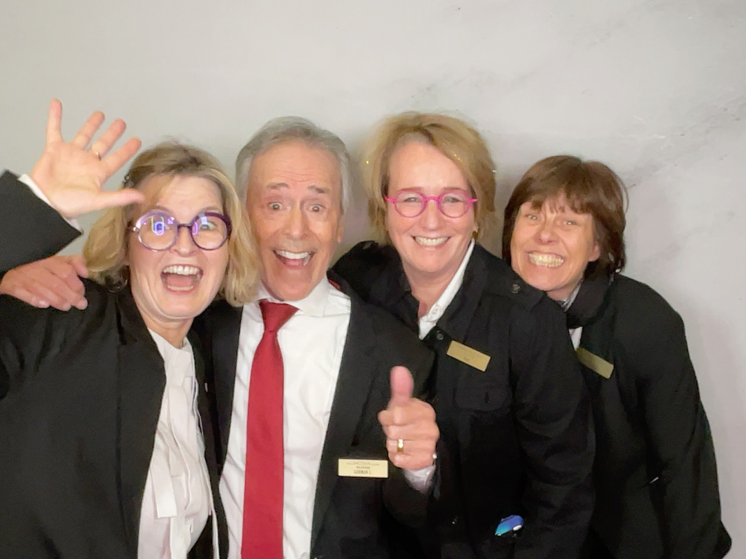 Four friendly volunteers pose happily for a photo.